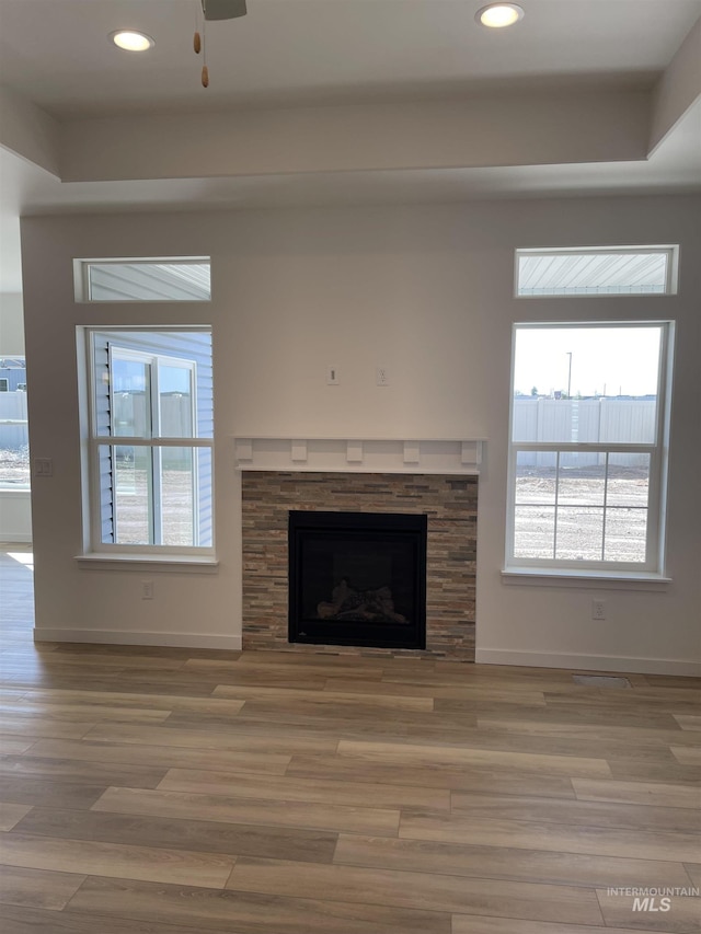 unfurnished living room featuring recessed lighting, baseboards, and wood finished floors