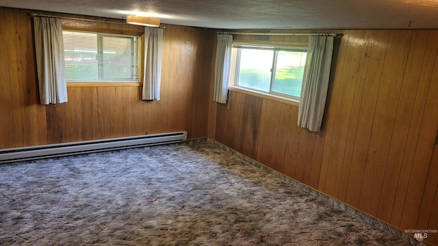 17 W 208 S, Burley, ID 83318 - carpeted spare room featuring a baseboard heating unit, wood walls, and a textured ceiling