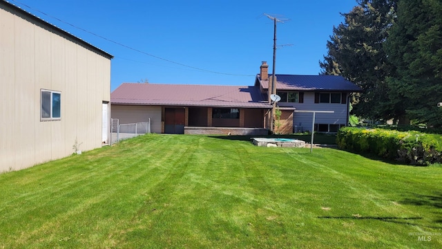 17 W 208 S, Burley, ID 83318 - back of house featuring a lawn, metal roof, and a garage