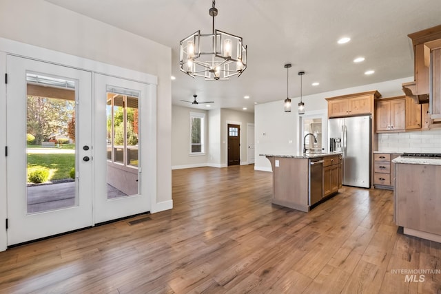 74 E Ranch Dr, Eagle, ID 83616 - kitchen with appliances with stainless steel finishes, a chandelier, open floor plan, french doors, and recessed lighting