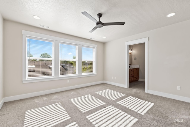 74 E Ranch Dr, Eagle, ID 83616 - unfurnished bedroom featuring light carpet, a textured ceiling, recessed lighting, ensuite bath, and a ceiling fan