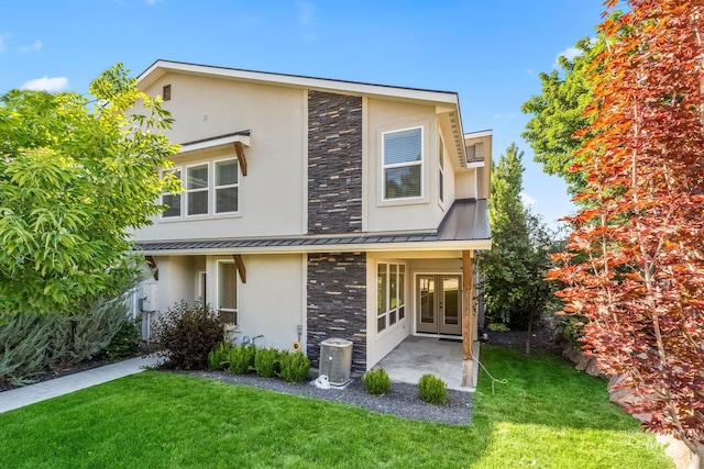 74 E Ranch Dr, Eagle, ID 83616 - view of front of property with french doors, a standing seam roof, stucco siding, and a front lawn