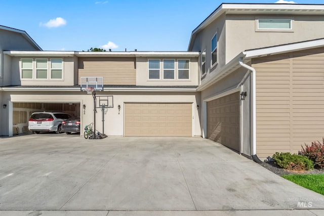 74 E Ranch Dr, Eagle, ID 83616 - view of front of house with an attached garage, stucco siding, and concrete driveway