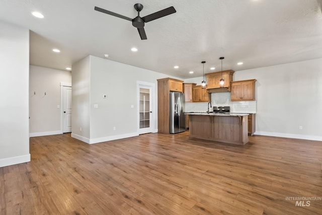 74 E Ranch Dr, Eagle, ID 83616 - kitchen with stainless steel refrigerator with ice dispenser, open floor plan, ceiling fan, recessed lighting, and tasteful backsplash