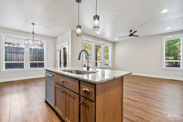 74 E Ranch Dr, Eagle, ID 83616 - kitchen featuring dishwasher, a textured ceiling, light wood-style floors, a ceiling fan, and a center island with sink