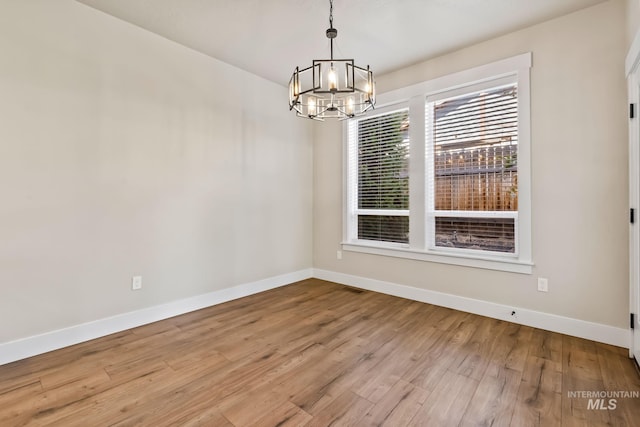 74 E Ranch Dr, Eagle, ID 83616 - unfurnished dining area featuring a chandelier and wood finished floors