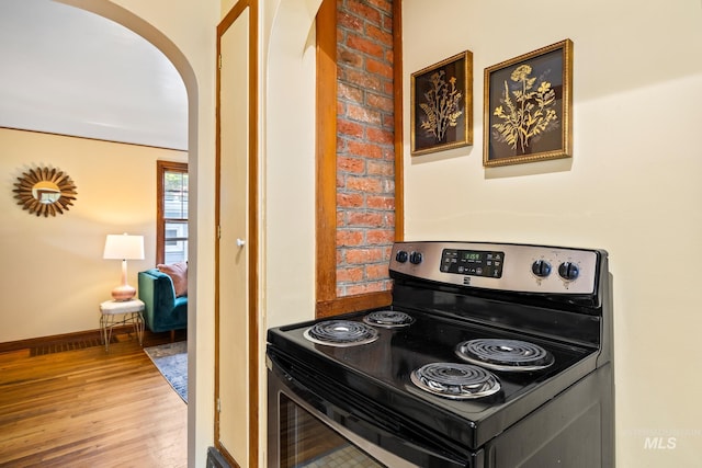 kitchen with black range with electric stovetop and wood-type flooring