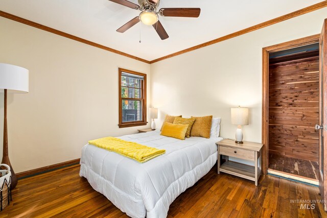 bedroom featuring dark hardwood / wood-style floors, ornamental molding, and ceiling fan