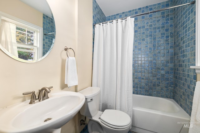 full bathroom featuring shower / bath combination with curtain, sink, and toilet