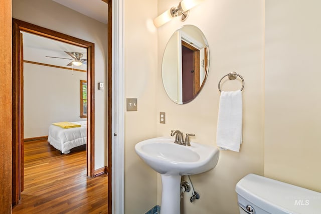 bathroom with ceiling fan, hardwood / wood-style floors, and toilet