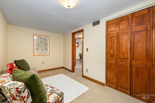 bedroom featuring a closet and light colored carpet