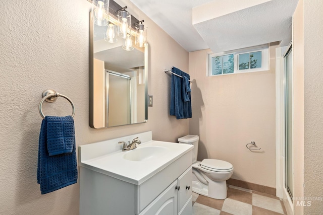 bathroom with vanity, a shower with shower door, toilet, and a textured ceiling