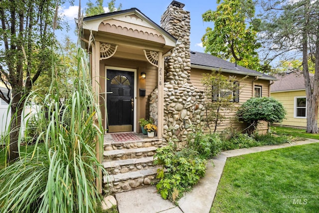 doorway to property featuring a yard