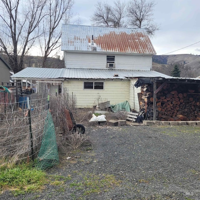 rear view of property featuring metal roof