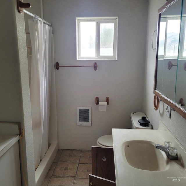 full bathroom featuring a wealth of natural light, heating unit, vanity, and a shower with shower curtain