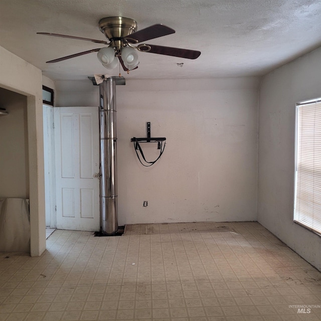 spare room with light floors and a textured ceiling