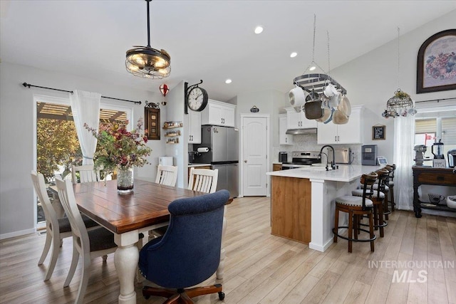 1440 Riverbend Pl, Twin Falls, ID 83301 - dining room with healthy amount of natural light, light wood-style flooring, recessed lighting, and vaulted ceiling