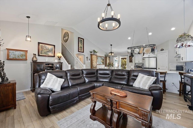 1440 Riverbend Pl, Twin Falls, ID 83301 - living area with light wood-style floors, a chandelier, stairway, and high vaulted ceiling