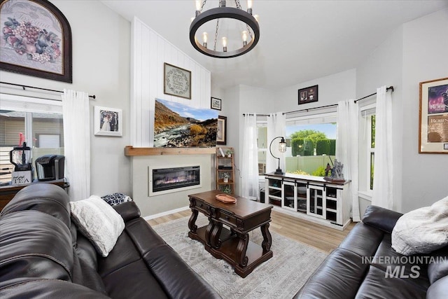 1440 Riverbend Pl, Twin Falls, ID 83301 - living room with a chandelier, wood finished floors, and a glass covered fireplace