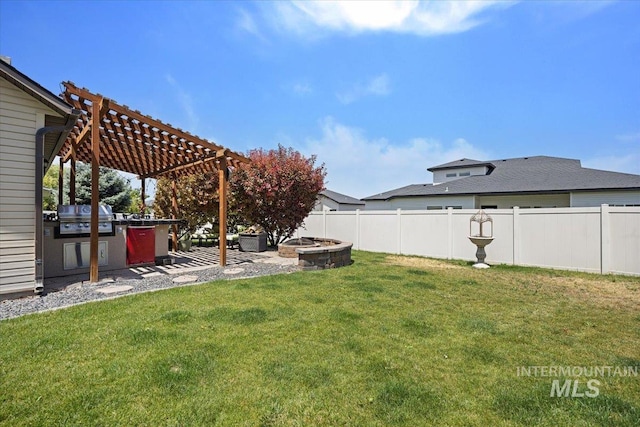 1440 Riverbend Pl, Twin Falls, ID 83301 - fenced backyard featuring a pergola, exterior kitchen, a patio, and a fire pit