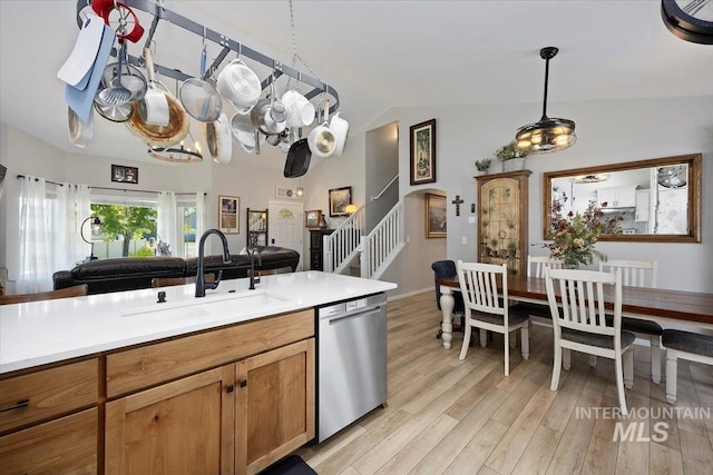 1440 Riverbend Pl, Twin Falls, ID 83301 - kitchen featuring stainless steel dishwasher, vaulted ceiling, light countertops, light wood-style floors, and decorative light fixtures