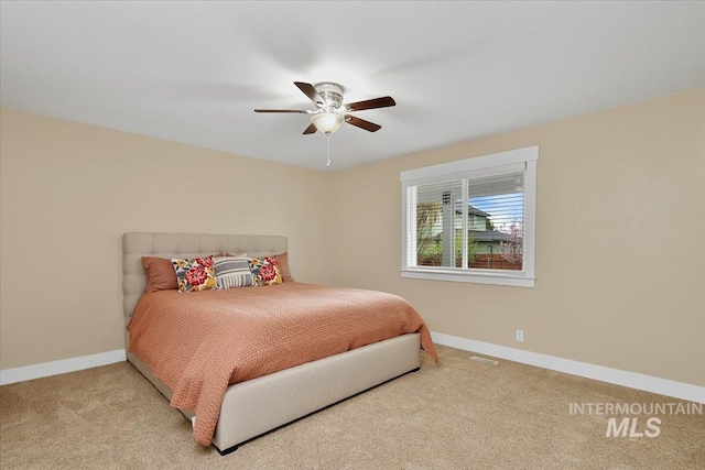 bedroom with baseboards, a ceiling fan, and carpet floors