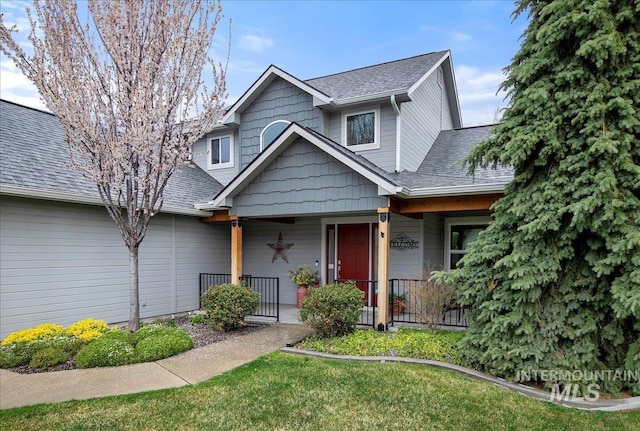 view of front of home with a shingled roof and covered porch