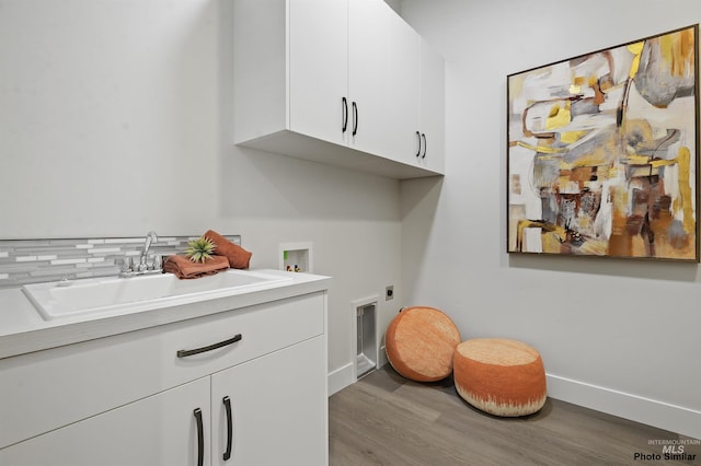 3053 Ajax Ave, Eagle, ID 83616 - laundry room featuring hookup for an electric dryer, cabinet space, wood finished floors, hookup for a washing machine, and baseboards