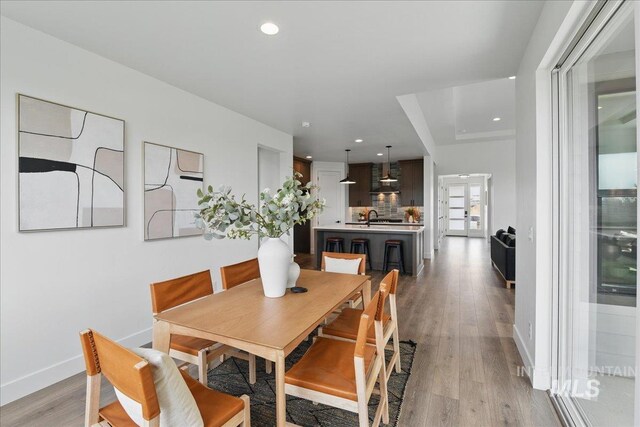7779 W Daybreak Run Ct, Meridian, ID 83646 - dining area with light wood-type flooring, baseboards, and recessed lighting