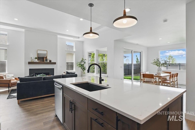 7779 W Daybreak Run Ct, Meridian, ID 83646 - kitchen with a sink, dark wood-style flooring, a fireplace, pendant lighting, and recessed lighting
