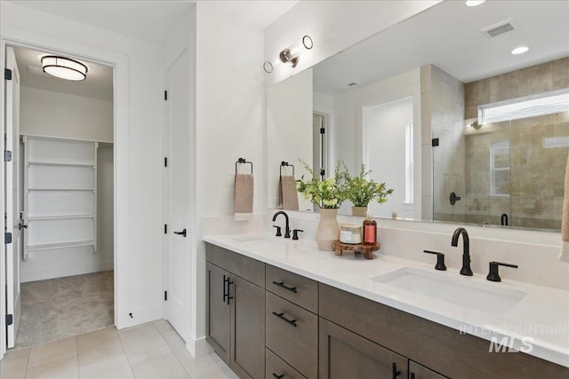 7779 W Daybreak Run Ct, Meridian, ID 83646 - bathroom with a stall shower, tile patterned floors, a spacious closet, double vanity, and recessed lighting