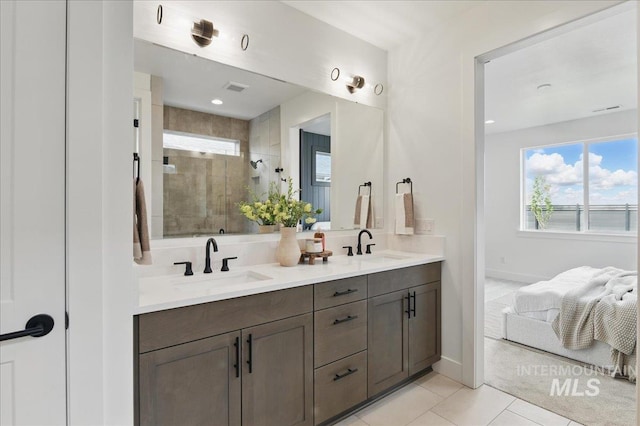 7779 W Daybreak Run Ct, Meridian, ID 83646 - full bathroom featuring a stall shower, tile patterned floors, baseboards, and double vanity