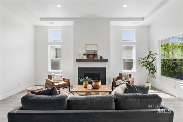 7779 W Daybreak Run Ct, Meridian, ID 83646 - living area with wood finished floors, a tile fireplace, plenty of natural light, recessed lighting, and baseboards