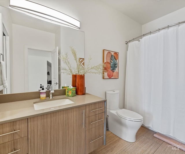 1681 W Idaho St, Boise, ID 83702 - full bath with curtained shower, wood finished floors, toilet, and vanity