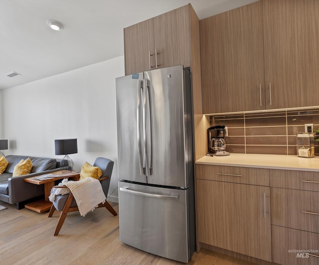 1681 W Idaho St, Boise, ID 83702 - kitchen with open floor plan, light wood-style floors, light countertops, visible vents, and freestanding refrigerator