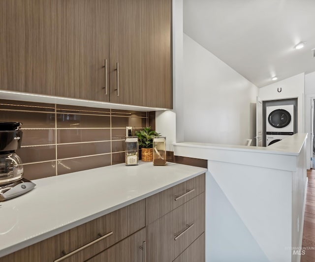 1681 W Idaho St, Boise, ID 83702 - interior space with decorative backsplash, light countertops, and stacked washer / dryer