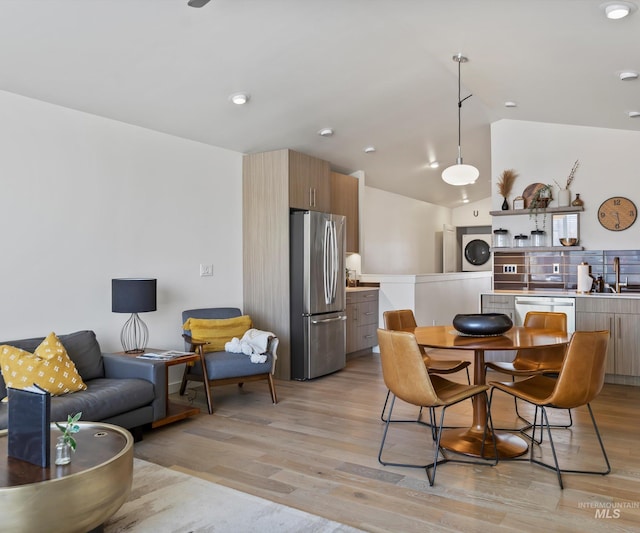 1681 W Idaho St, Boise, ID 83702 - dining area featuring lofted ceiling, stacked washer and clothes dryer, and light wood finished floors