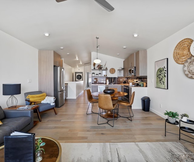 1681 W Idaho St, Boise, ID 83702 - dining area with light wood-style flooring, vaulted ceiling, baseboards, stacked washer and clothes dryer, and ceiling fan