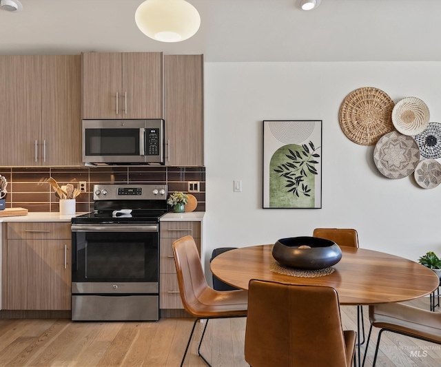 1681 W Idaho St, Boise, ID 83702 - kitchen with stainless steel appliances, light countertops, backsplash, and light wood-style flooring
