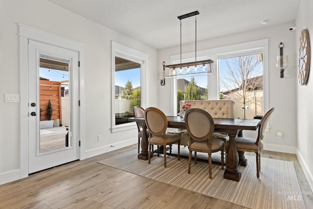 486 E Andes Dr, Kuna, ID 83634 - dining area with baseboards, a wealth of natural light, and light wood-style floors
