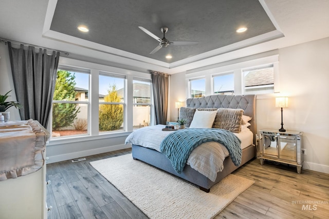 486 E Andes Dr, Kuna, ID 83634 - bedroom featuring wood-type flooring, multiple windows, baseboards, and a raised ceiling