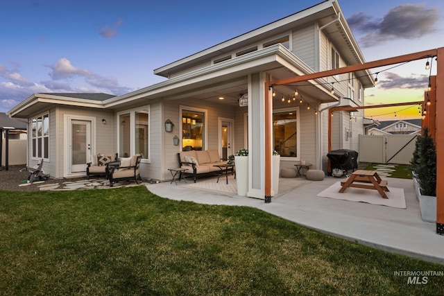 486 E Andes Dr, Kuna, ID 83634 - rear view of house featuring a patio, a gate, an outdoor hangout area, fence, and a lawn