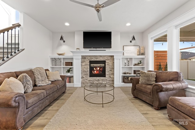 486 E Andes Dr, Kuna, ID 83634 - living area with ceiling fan, a fireplace, light wood-style flooring, recessed lighting, and stairway