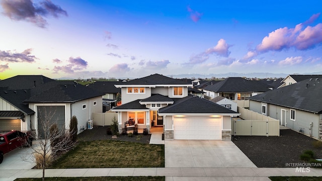 486 E Andes Dr, Kuna, ID 83634 - view of front of house with a residential view, stone siding, a gate, and driveway