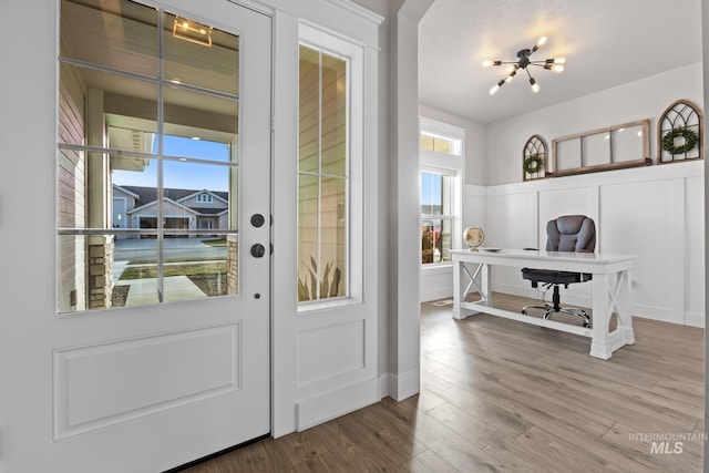 486 E Andes Dr, Kuna, ID 83634 - doorway featuring a decorative wall, wainscoting, and wood finished floors