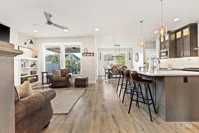 486 E Andes Dr, Kuna, ID 83634 - living room featuring light wood-style flooring, ceiling fan, baseboards, and recessed lighting