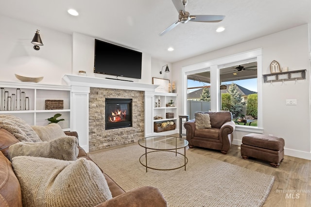 486 E Andes Dr, Kuna, ID 83634 - living room with baseboards, a stone fireplace, ceiling fan, recessed lighting, and wood finished floors