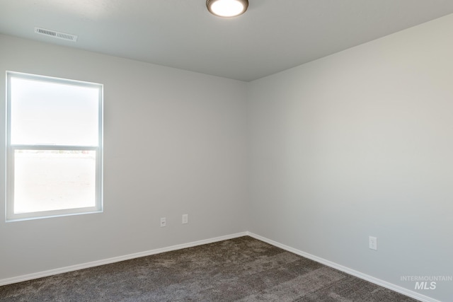 310 Chalcedony Ave, Caldwell, ID 83605 - unfurnished room featuring baseboards, visible vents, and dark carpet