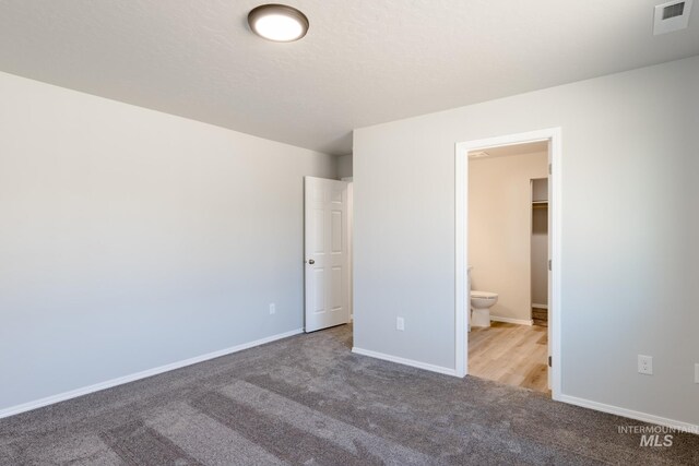 310 Chalcedony Ave, Caldwell, ID 83605 - unfurnished bedroom featuring ensuite bathroom, baseboards, visible vents, and carpet flooring
