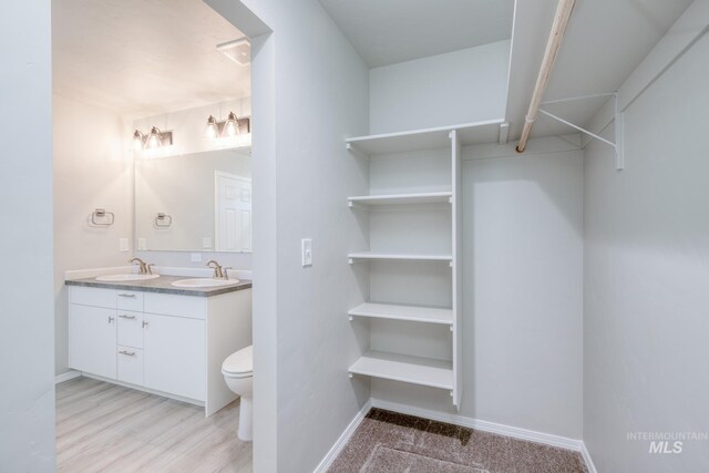 310 Chalcedony Ave, Caldwell, ID 83605 - full bathroom featuring double vanity, toilet, baseboards, and a sink